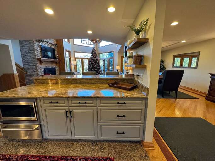 Large updated kitchen with granite countertops, upscale appliances and breakfast bar