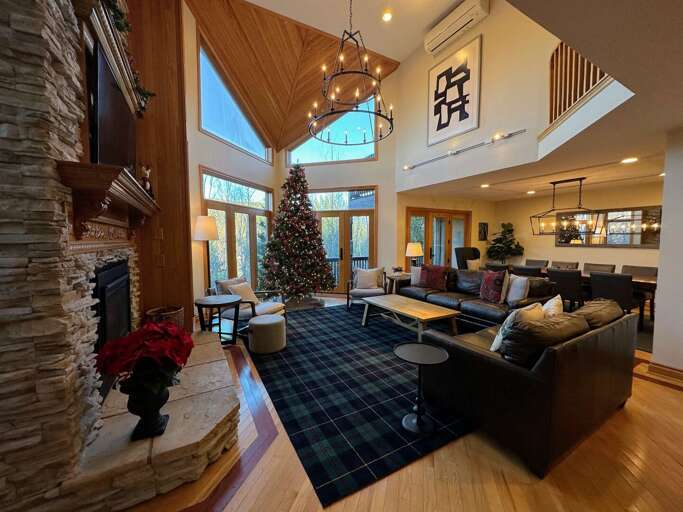 Living room with walkout upper deck and open concept Dining and Kitchen areas
