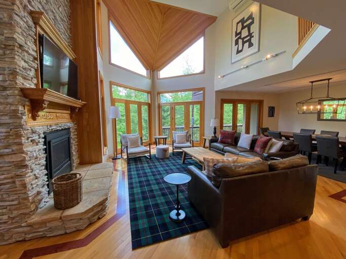 Living room with walkout upper deck and open concept Dining and Kitchen areas