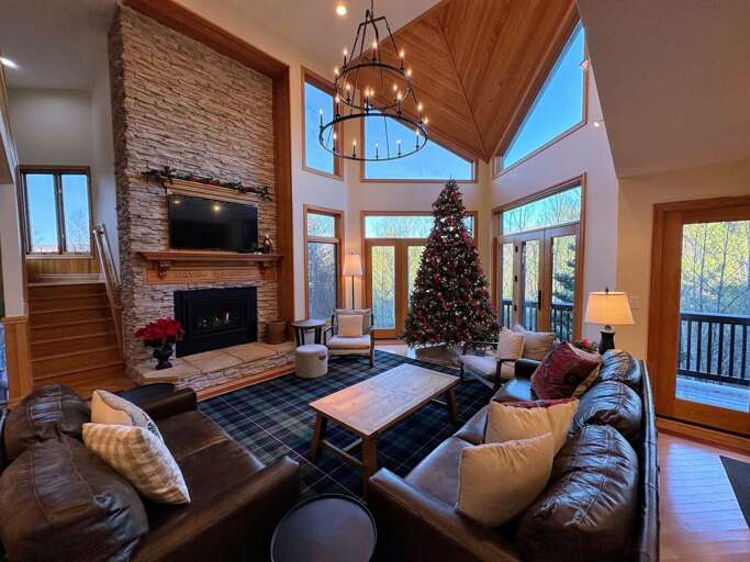 Living room with walkout upper deck and open concept Dining and Kitchen areas