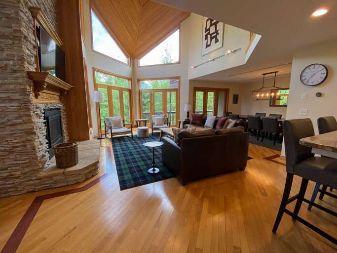 Living room with walkout upper deck and open concept Dining and Kitchen areas