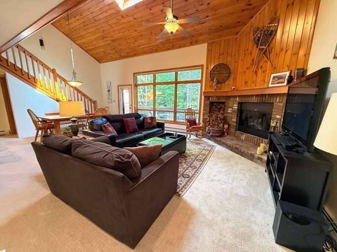 Main Level Living Area with Fireplace, TV and deck