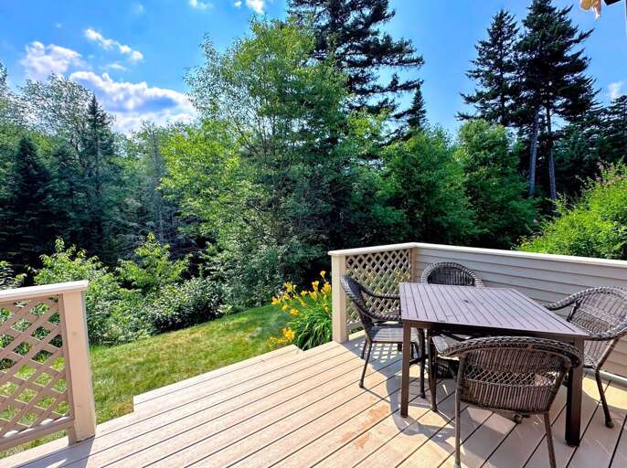 Back deck with seating and golf course views, perfect for relaxing after a day of adventure