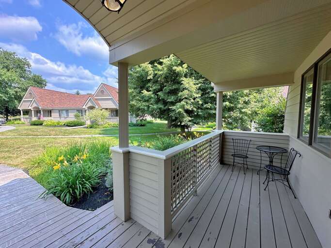 House View From Shaded Porch With Furniture And Garden House View From Shaded Porch With Furniture And Garden