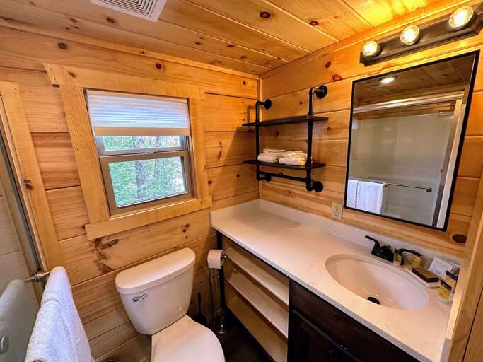 The bathroom is equipped with a shower.
