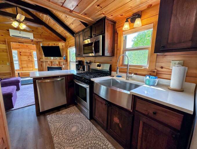 The kitchen has a dishwasher, microwave, oven, and refrigerator as well as a stackable washer/dryer.