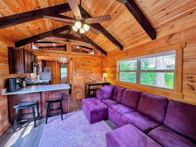 View of the living room, dining, and kitchen from the gas fireplace.