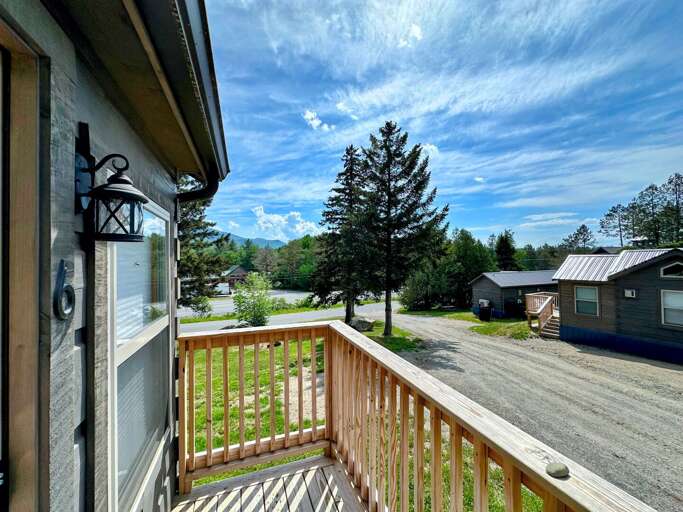 View From Vacation Rental Balcony With Pine Trees And Blue Sky