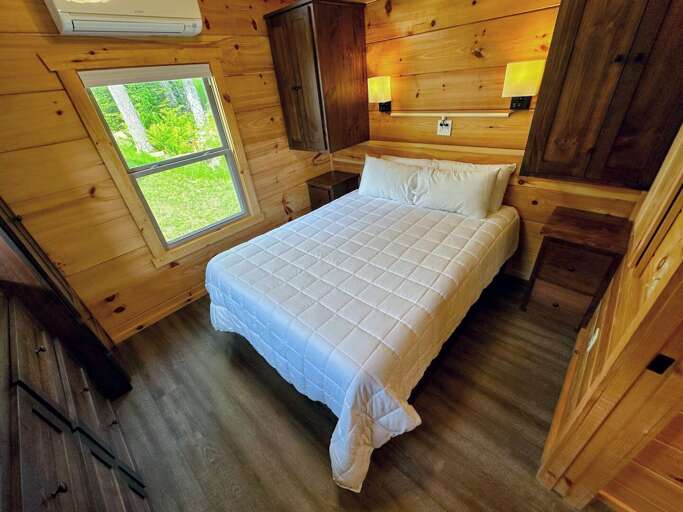 The main bedroom is past the kitchen and bathroom and has a queen bed.