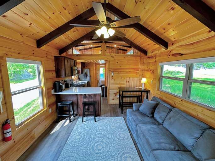 The main living space has a couch, TV, and gas fireplace with a table. The main living space has a couch, TV, and gas fireplace with a table.