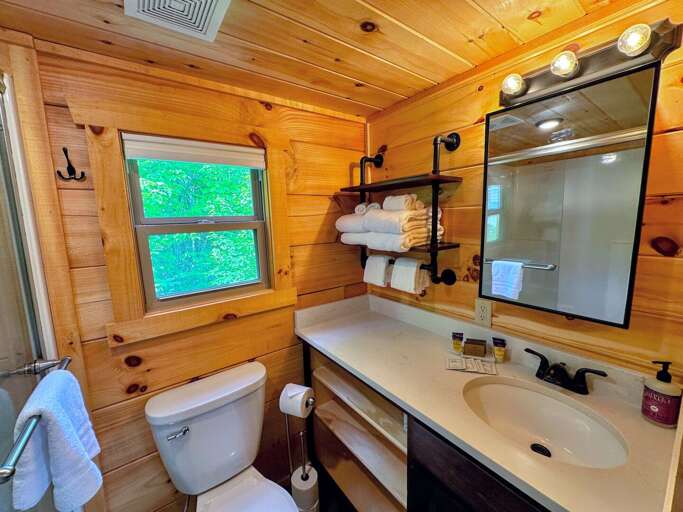 The bathroom is equipped with a shower.
