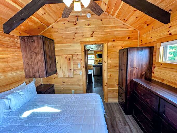 The main bedroom is past the kitchen and bathroom and has a queen bed.