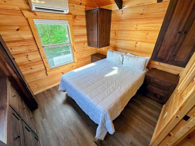 The main bedroom is past the kitchen and bathroom and has a queen bed.