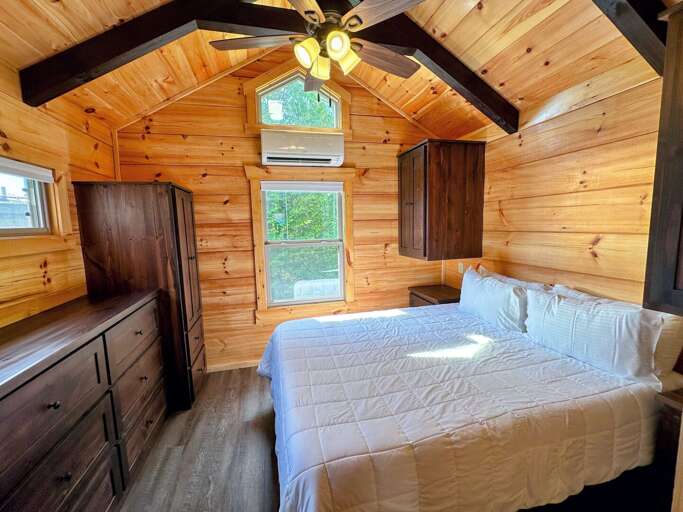The main bedroom is past the kitchen and bathroom and has a queen bed.