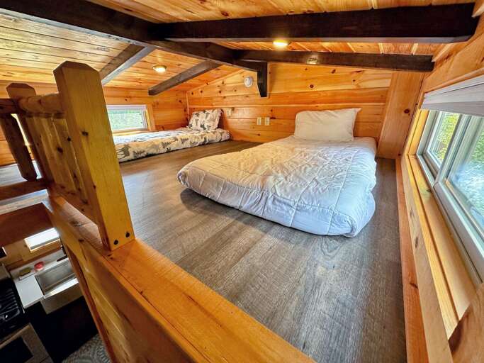 The loft is accessed via stairs off of the kitchen and has two twin beds The loft is accessed via stairs off of the kitchen and has two twin beds