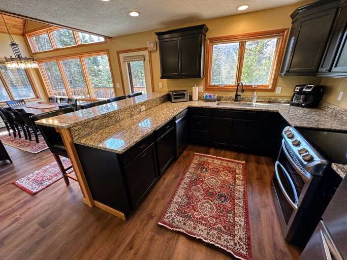 Newly updated kitchen with stainless steel appliances and granite countertops