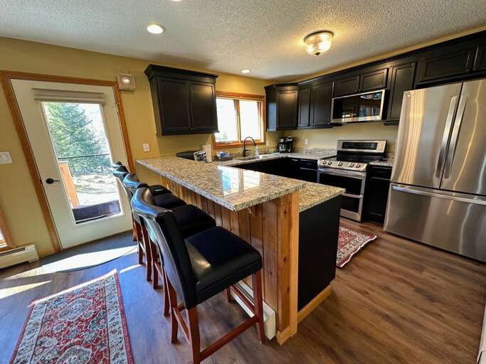 Newly updated kitchen with stainless steel appliances and granite countertops