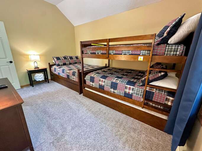 Upstairs bunk room with a full over full bunk bed and one full bed, private bath and TV- up to 5 sleeping spaces