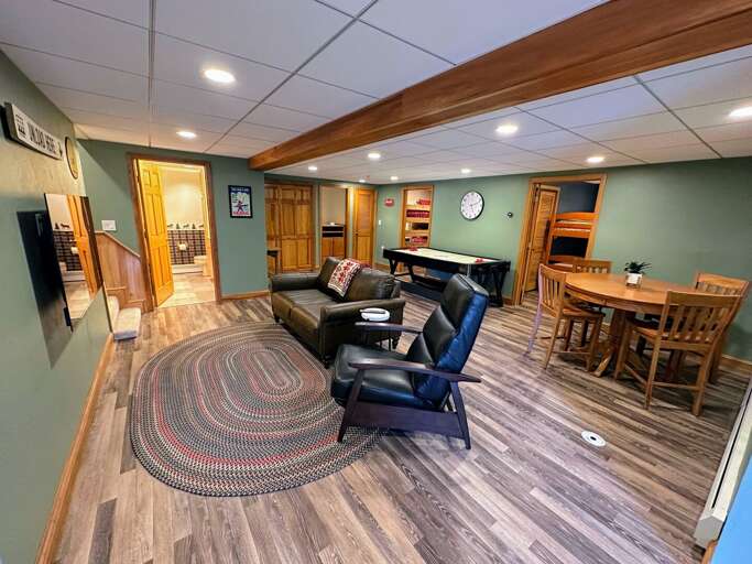 Lower level living area with air hockey table and TV