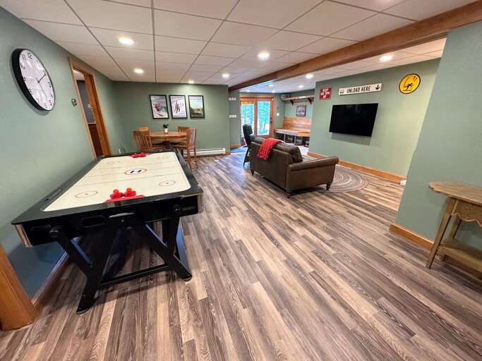 Lower level living area with air hockey table and TV