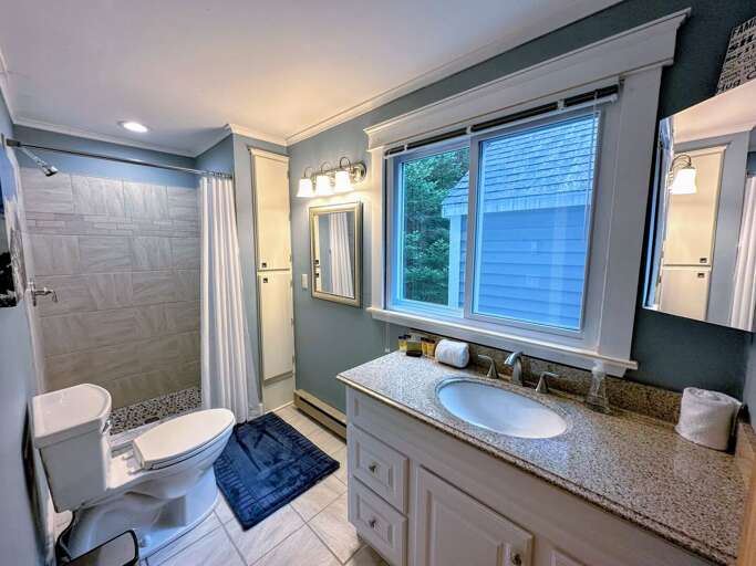 Lower level shared bathroom with shower