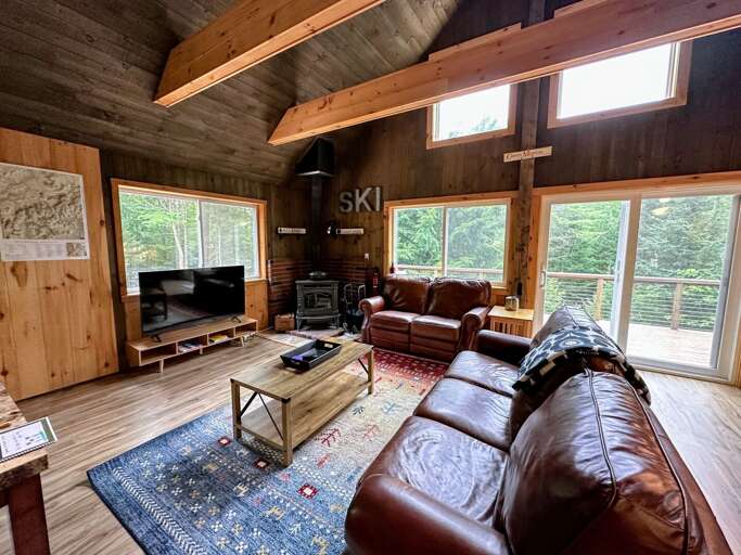 Upper level living area with wood stove, TV and walkout slider