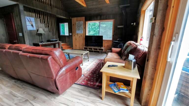Upper level living area with wood stove, TV and walkout slider