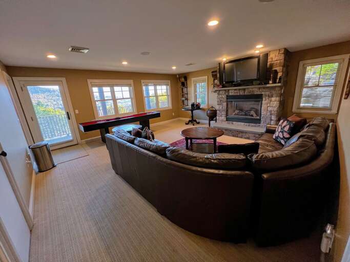Lower level living area with shuffleboard, gas fireplace and TV Lower level living area with shuffleboard, gas fireplace and TV