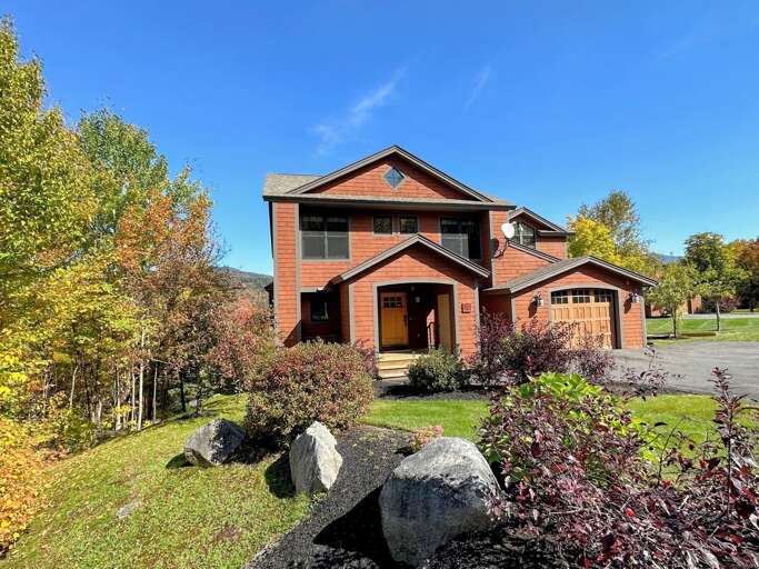 Two-story Residential House With A Garage And Landscaped Garden Two-story Residential House With A Garage And Landscaped Garden
