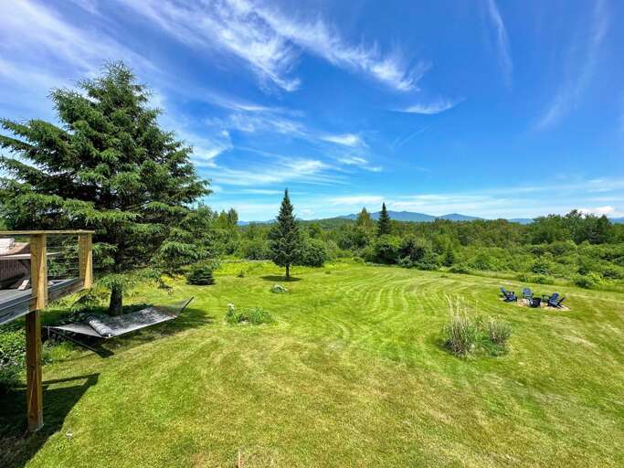 Below back deck are a hammock, fire pit and grill.