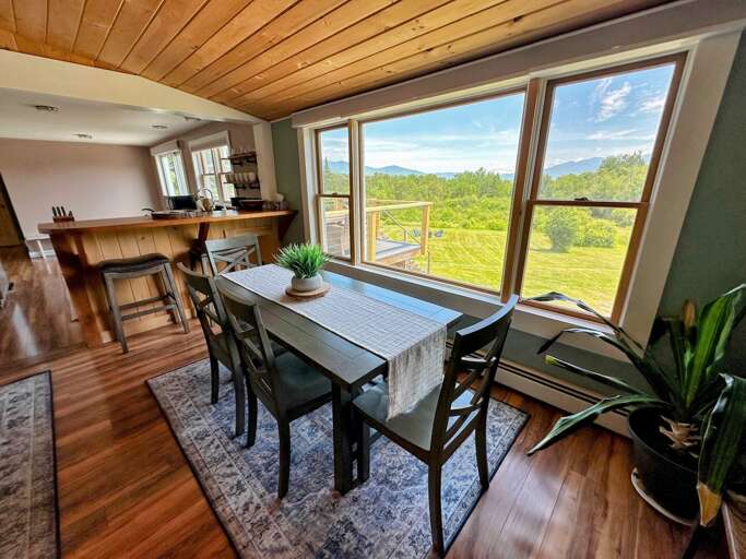 Dining area adjacent to kitchen and living areas with breakfast bar