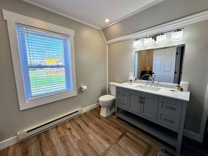 Main level full bath with shower/tub combo and laundry