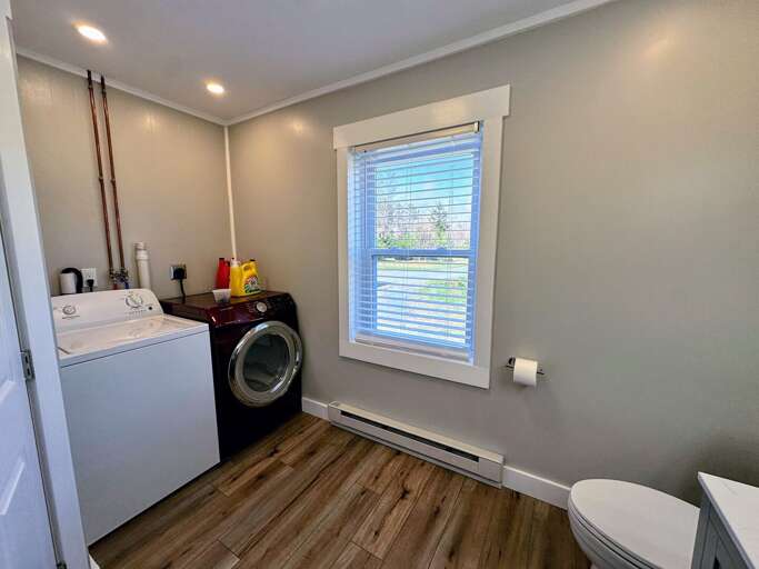 Main level full bath with shower/tub combo and laundry