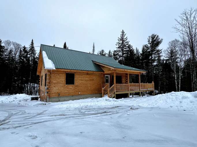 Wooden Cabin In Snowy Landscape