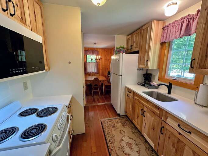Galley kitchen with drip coffee maker, fridge/freezer, range and microwave