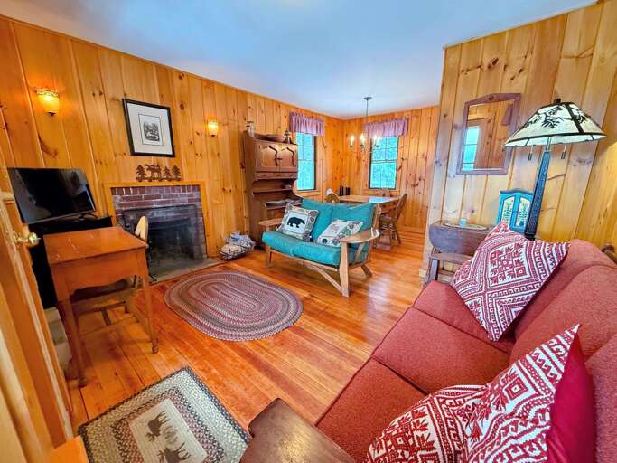 The living area offers a TV and Fireplace with mountain views. Imagine chilling here after a day of exploration or adventure!