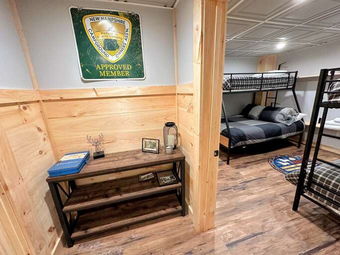 Lower level bunk room with one twin-over-full bunk and one twin-over-twin bunk.