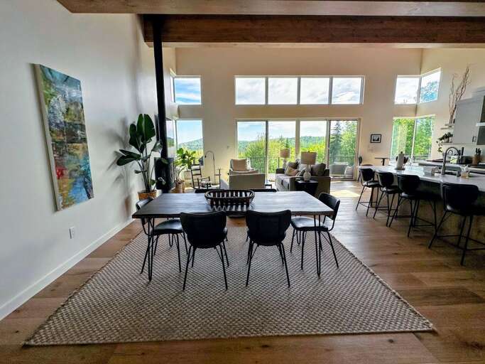 Lovely kitchen, dining, and living space on the main level with large windows and mountain views.