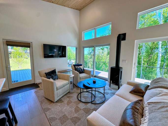 Living area with TV, fireplace and adjacent kitchen and dining area