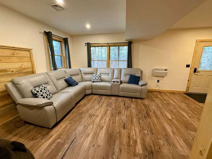 Newly updated Lower Level Common Area with game table, large sectional and TV. This room also is the entrance to the home.