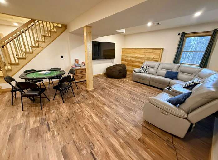 Newly updated Lower Level Common Area with game table, large sectional and TV. This room also is the entrance to the home.