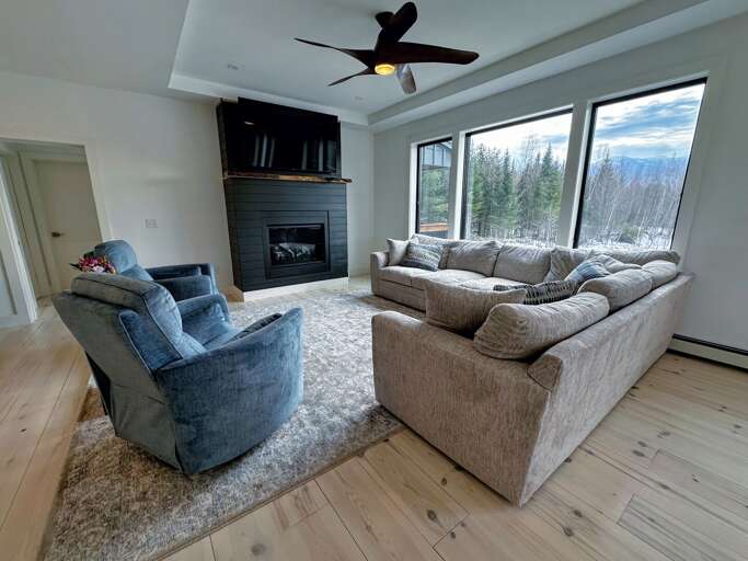 Living Room With Furniture And Fireplace, Mountain View Through Windows