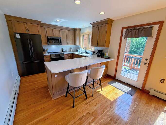 Newly renovated kitchen with standard appliances and breakfast bar