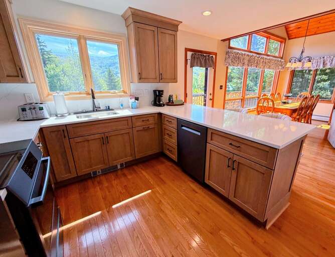 Newly renovated kitchen with standard appliances and breakfast bar