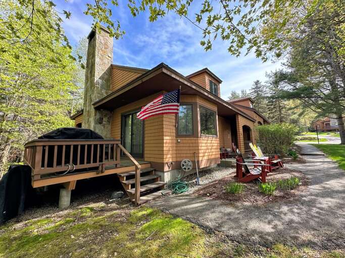 Wooden House With American Flag And Outdoor Seating Wooden House With American Flag And Outdoor Seating