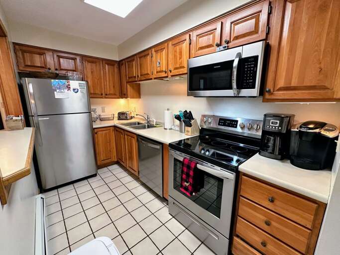 Galley kitchen with pass-through window to living area Galley kitchen with pass-through window to living area
