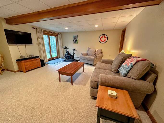 Lower level living area with TV, exercise bike and foosball Lower level living area with TV, exercise bike and foosball