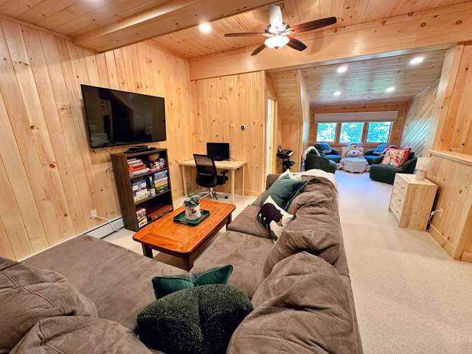 Loft with living area, TV, desk, games, and bunk beds