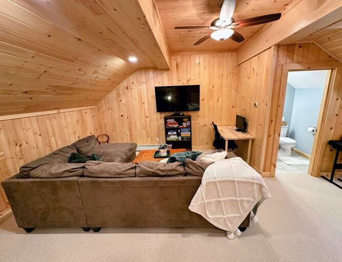 Loft with living area, TV, desk, games, and bunk beds