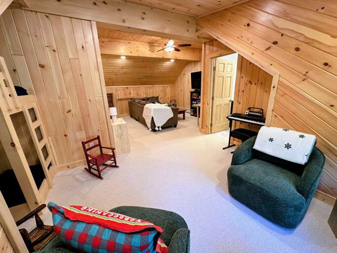 Loft with living area, TV, desk, games, and bunk beds